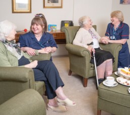 Carers and residents enjoying a cup of tea